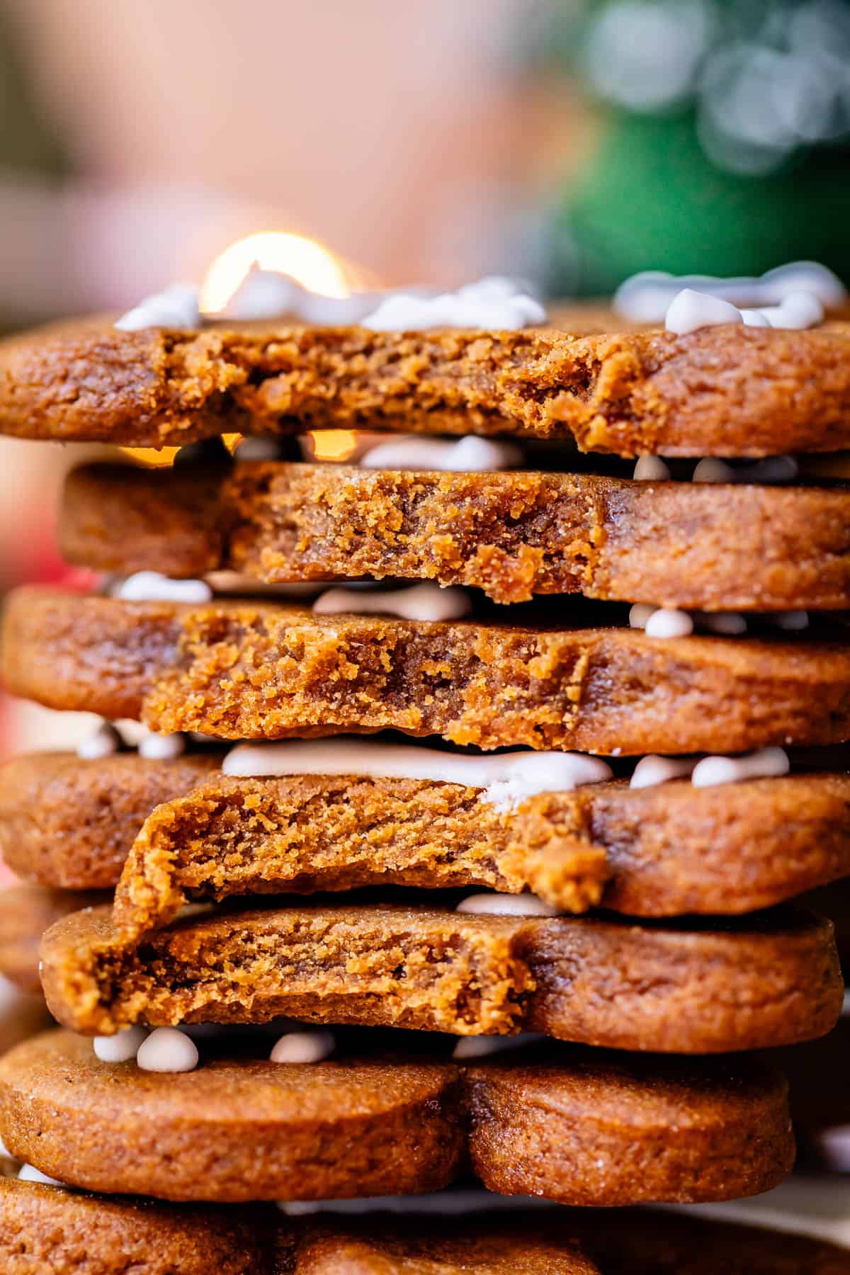 stack of very soft and chewy gingerbread men with bites taken out.