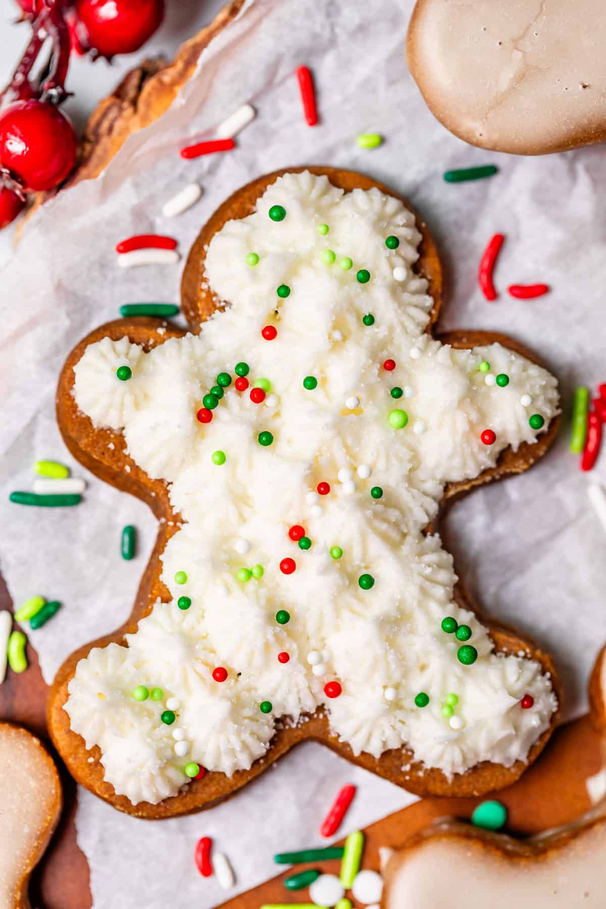 gingerbread cookie cut out with buttercream frosting and sprinkles.
