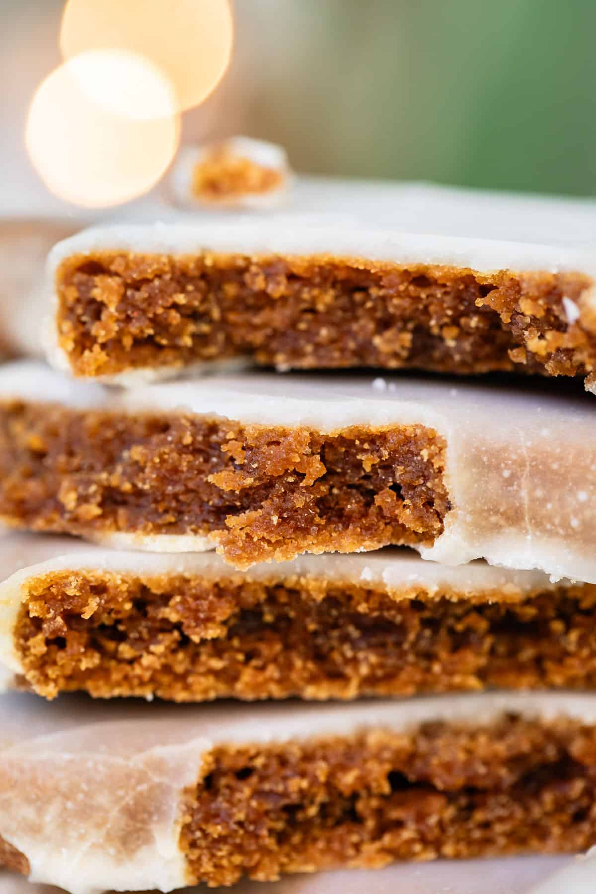close up of gingerbread cookie with glaze, broken in half.