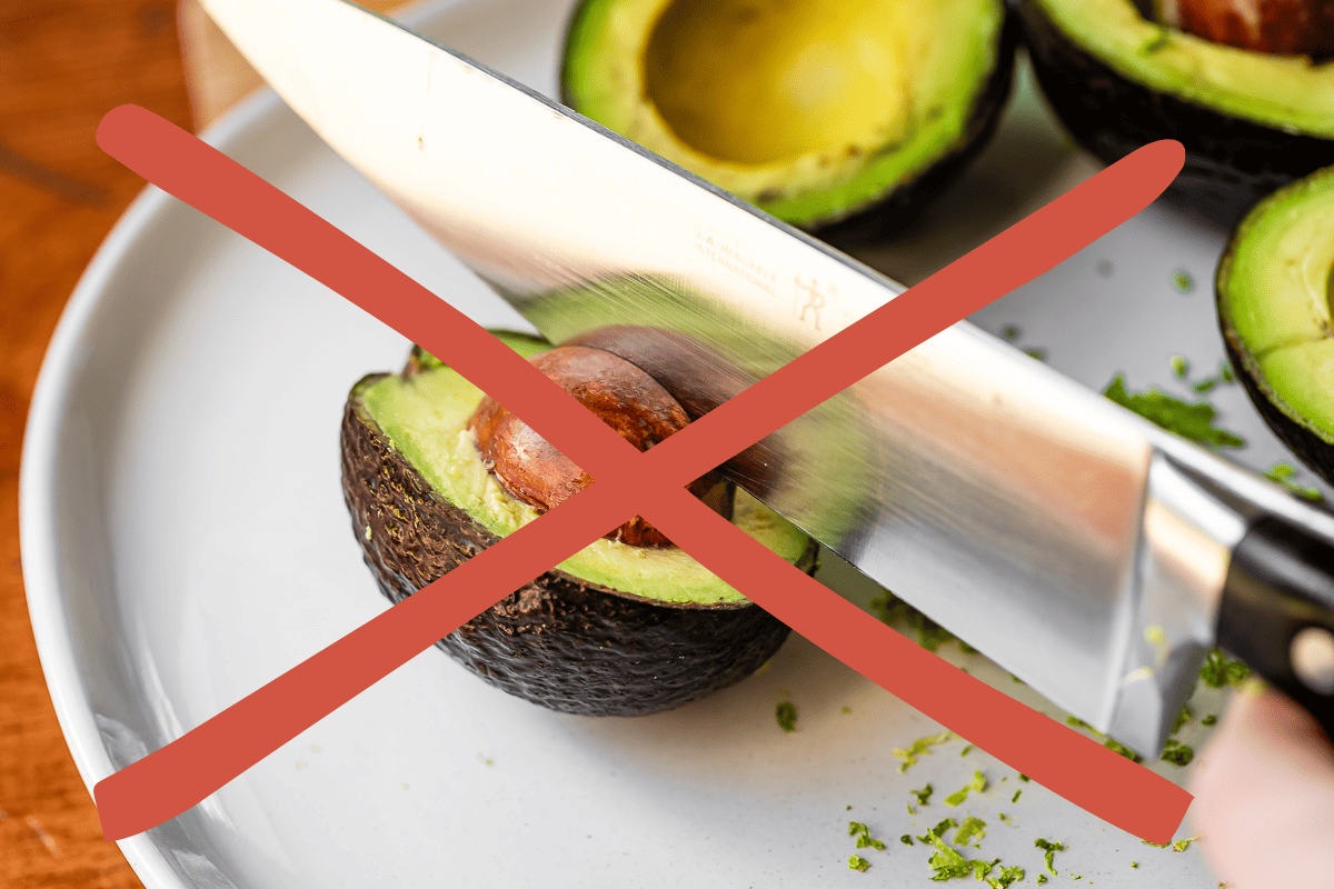 A chef's knife cutting into an avocado, with a red X blocking the image.