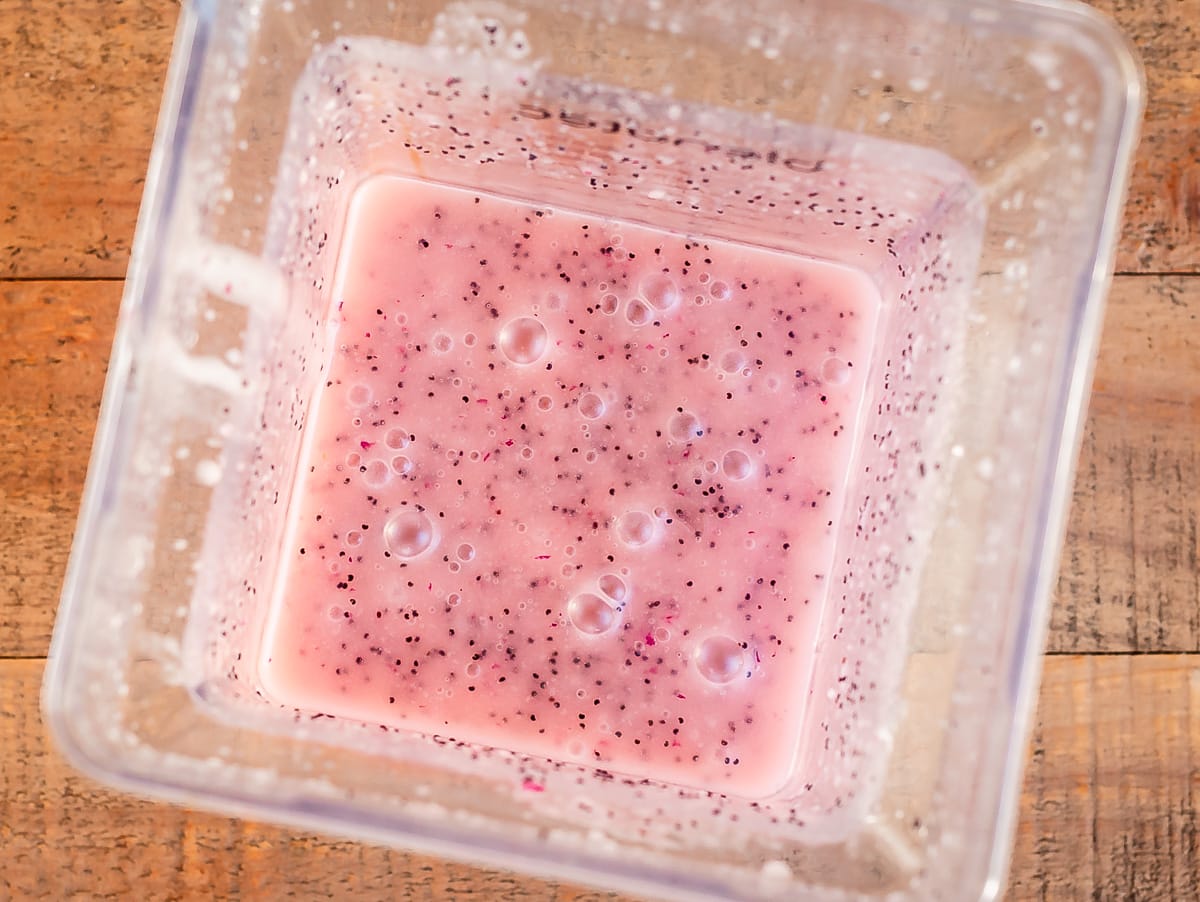 looking down into a blender at the blended poppyseed dressing.