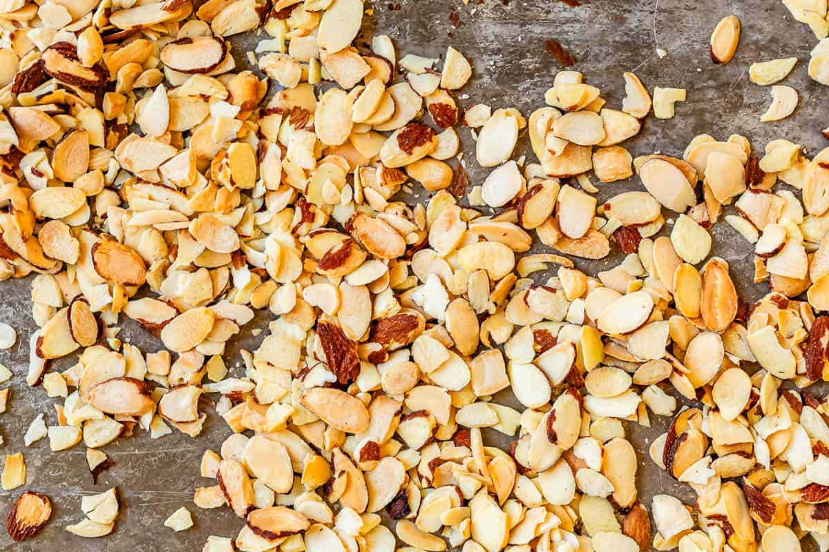 toasted, slivered almonds spread out on a metal sheetpan.