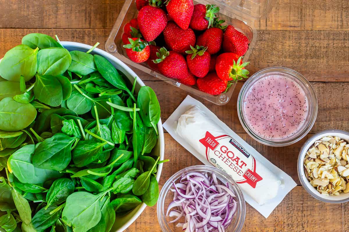 ingredients for strawberry spinach salad - almonds, onions, homemade dressing, etc.
