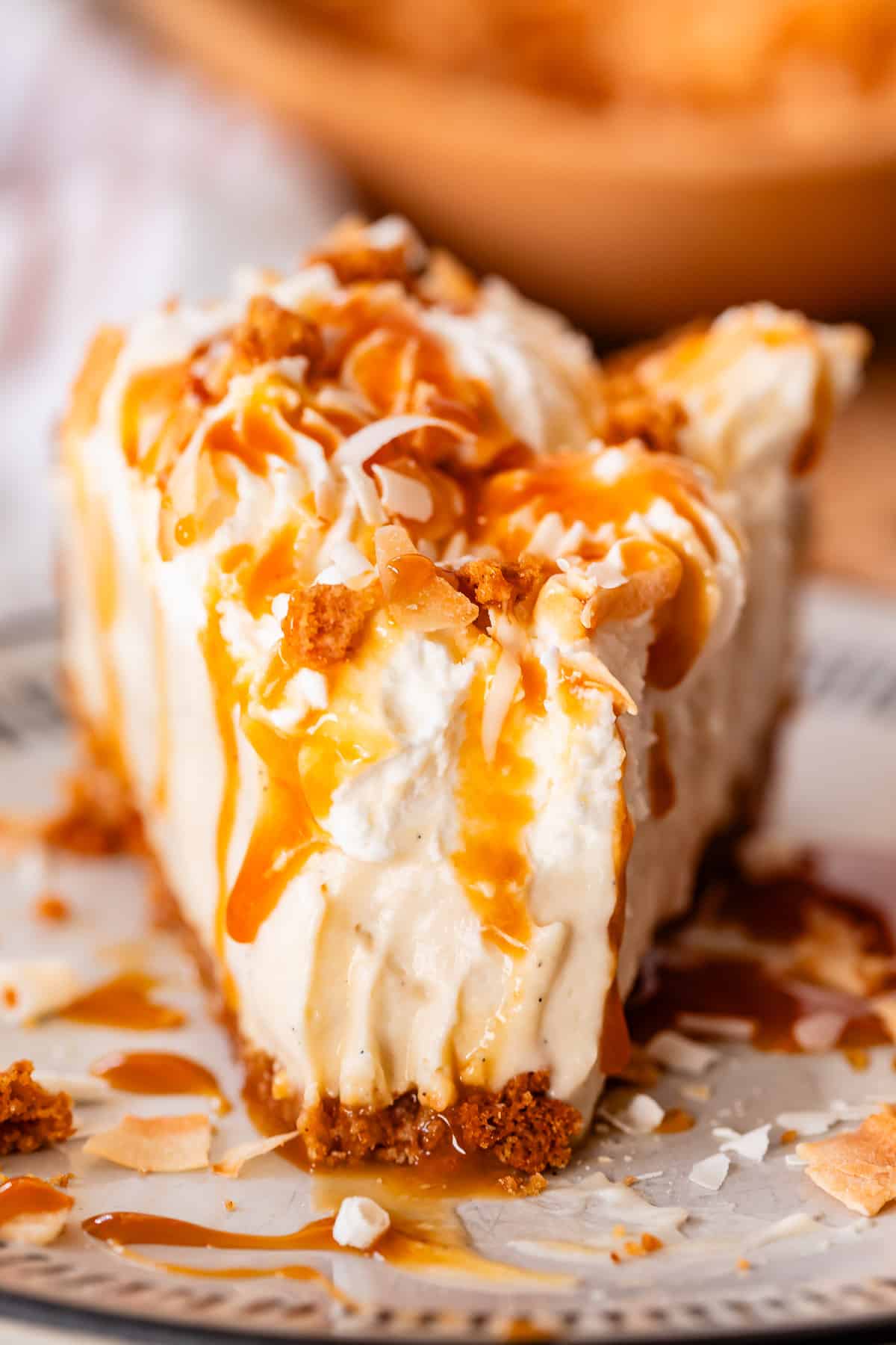 straight on shot of slice of coconut pie with a bite taken out.