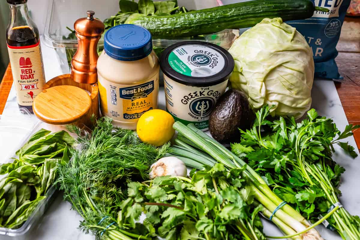 ingredients for green goddess like herbs, mayo, yogurt, fish sauce, and more.