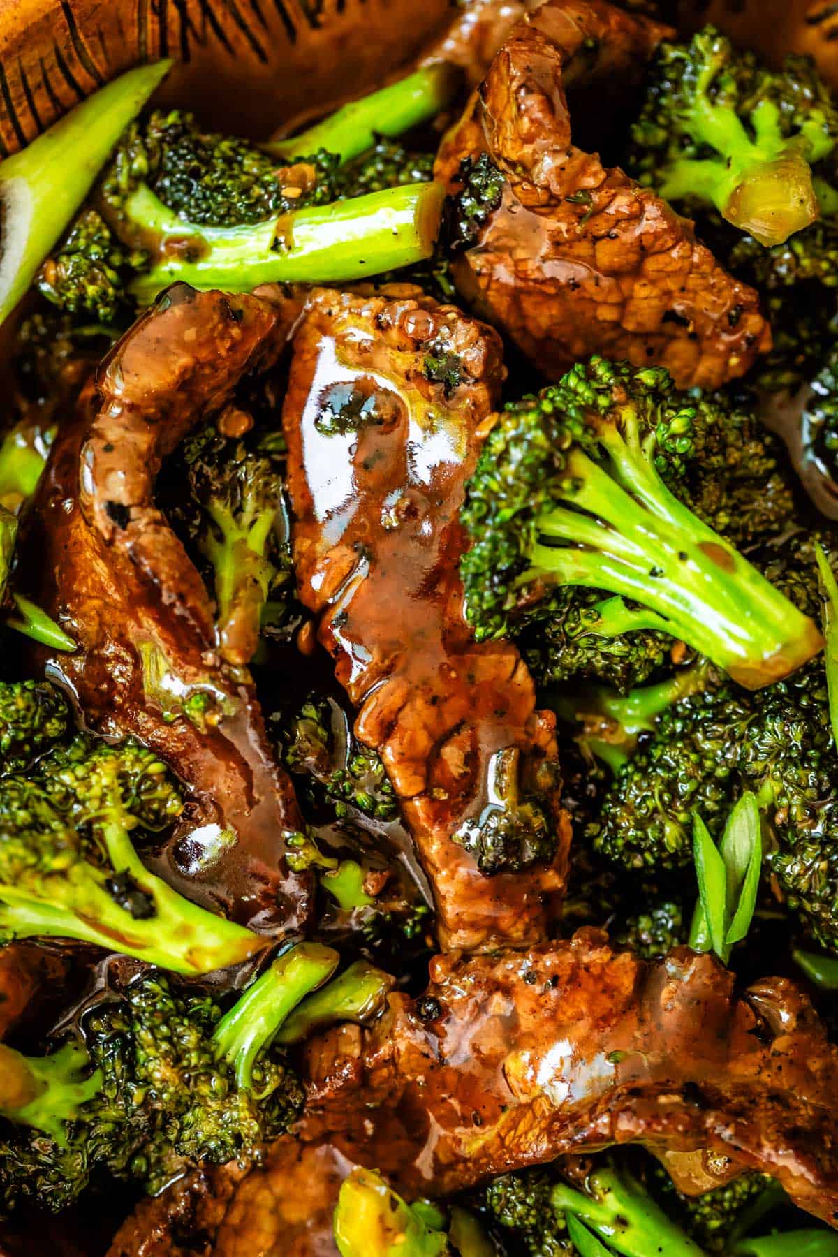 saucy beef strips and broccoli florets close up