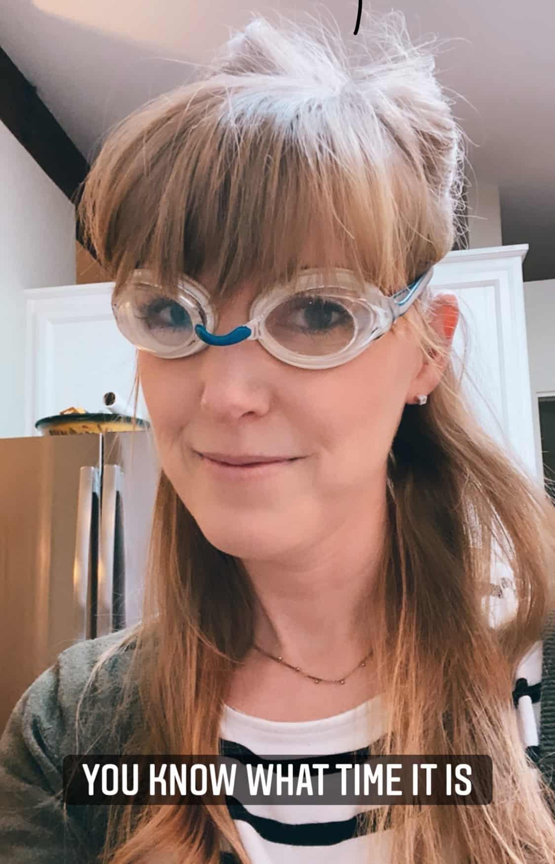 woman wearing goggles in kitchen