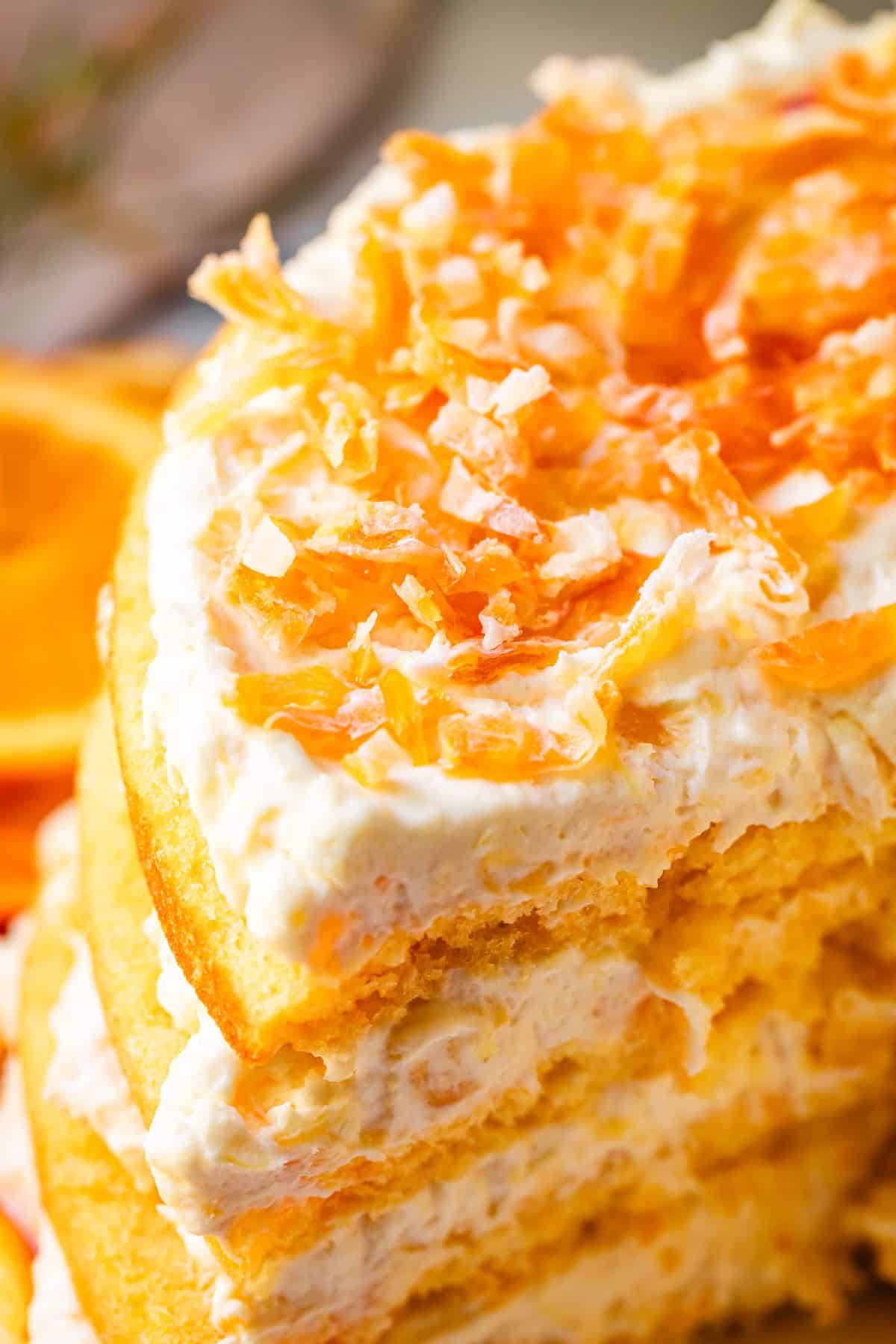 4 layer pig pickin' cake with golden cake and topping, plus chopped dried mandarin oranges as garnish.