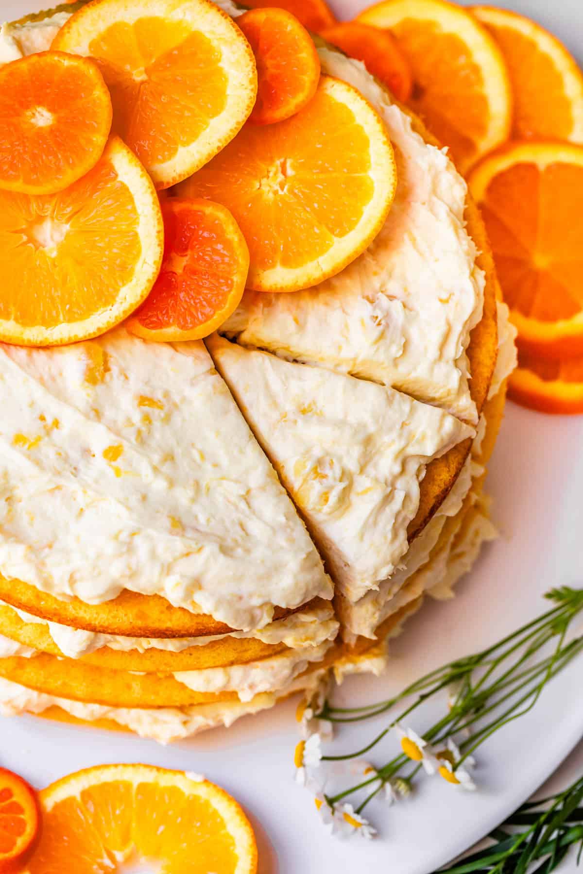 whole pig pickin' cake with a slice cur but not removed, and orange slices as garnish.