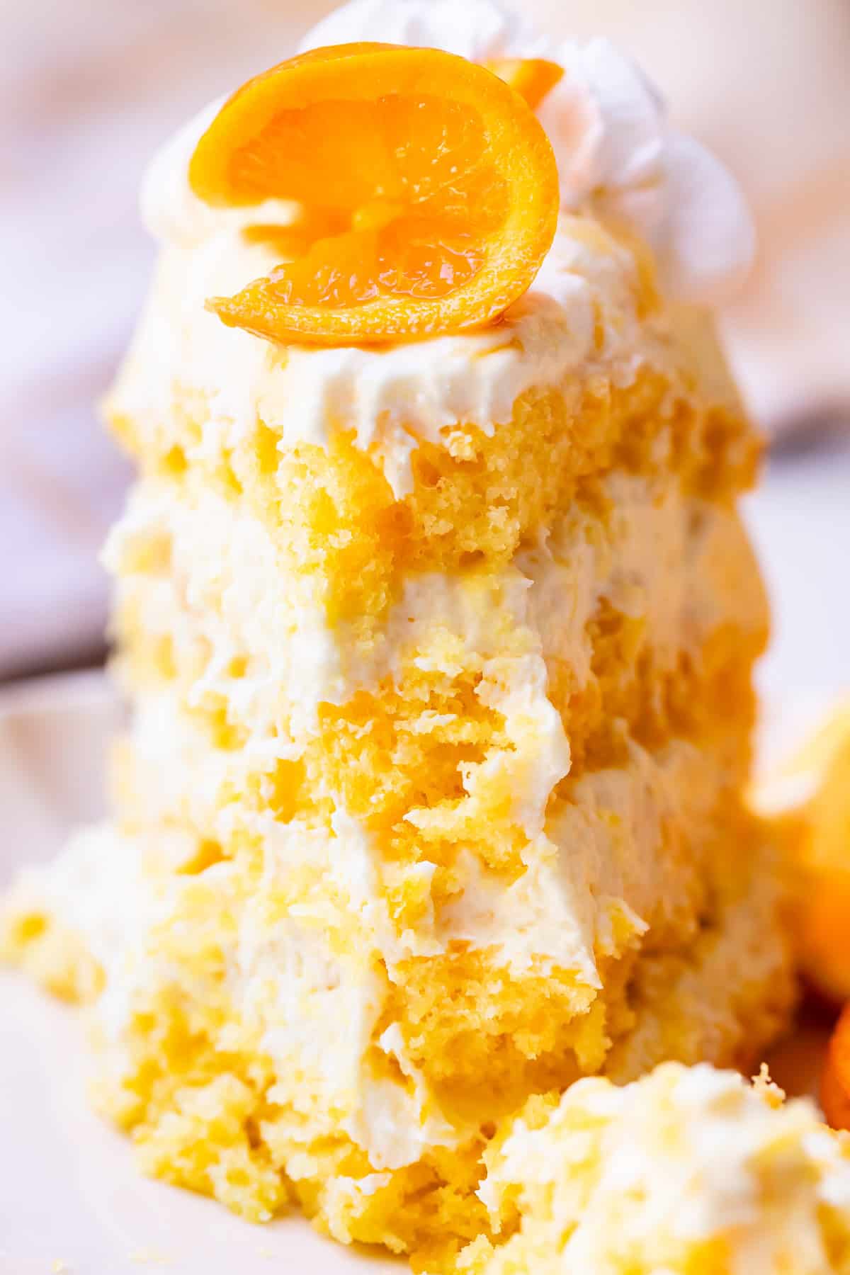 looking straight at a piece of sunshine cake with the first bite taken.