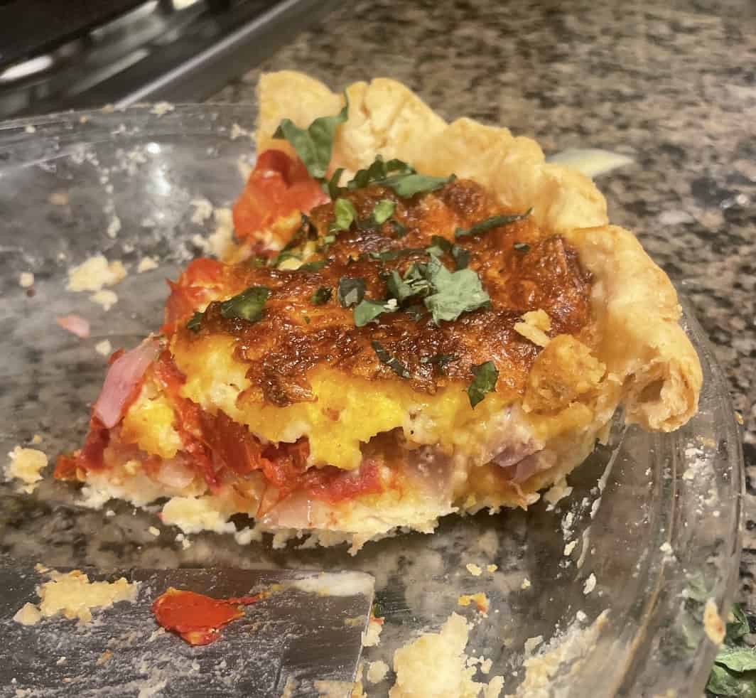 picture of tomato pie half eaten in the pan.