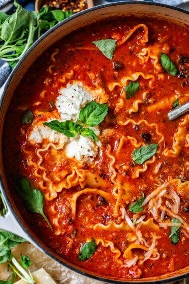pot filled with the marina broth, lasagna noodles, and cheesy topping of lasagna soup.