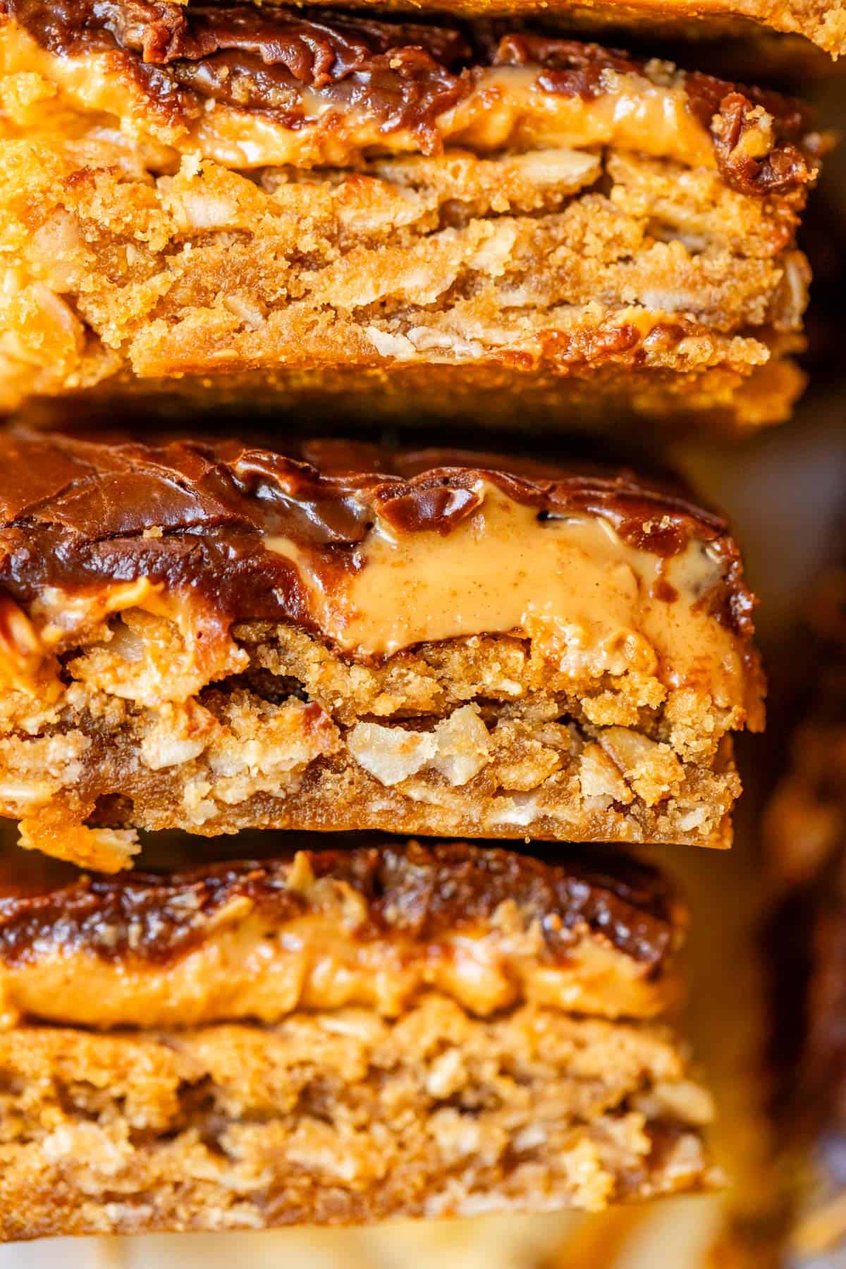 3 cut pieces of lunch lady bars stacked on top of each other showing the layers on the side.
