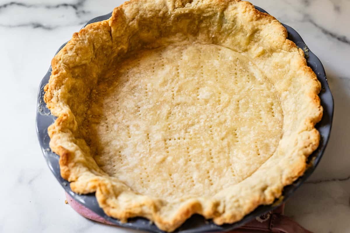 A home made pie crust shell ready to be filled to make a pie.