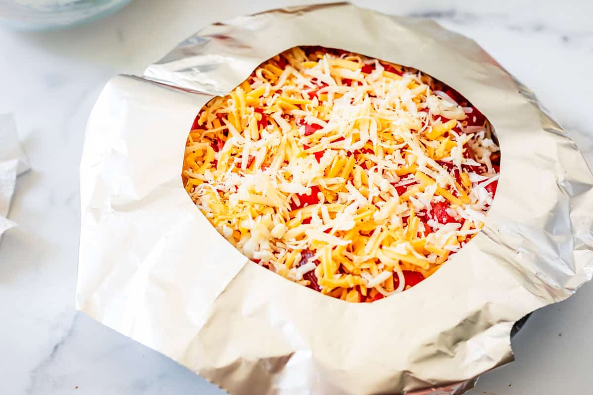 Using aluminum foil around a pie crust as a shield from burning in the oven.