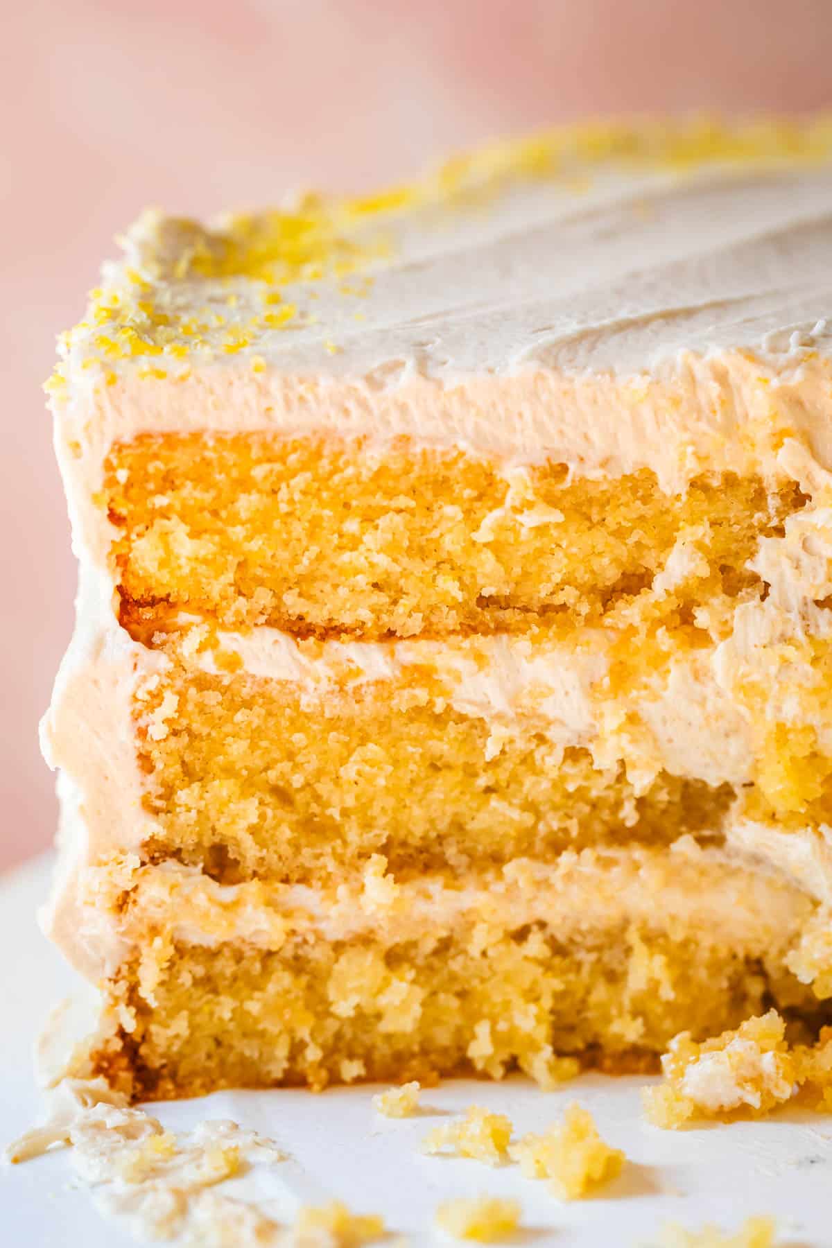 a cut into cornbread cake with honey frosting showing all three layers.