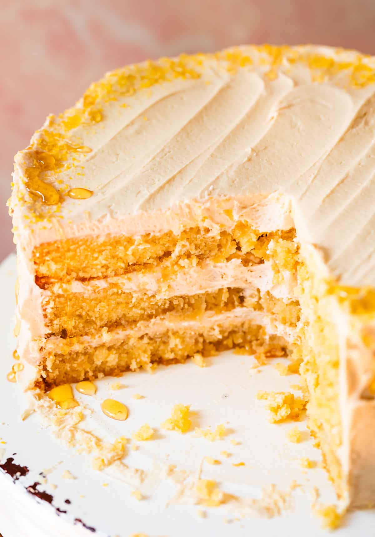 cornbread cake with whipped honey buttercream frosting with three layers.