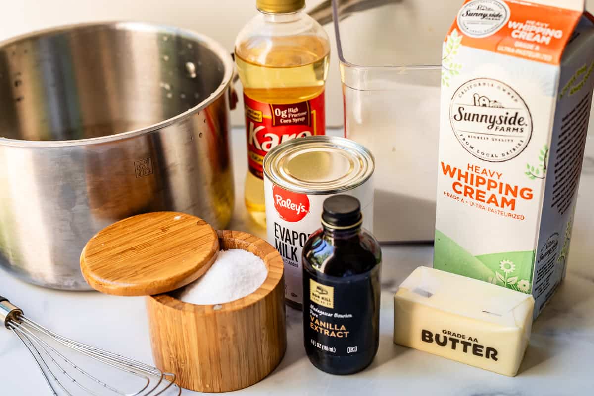 Ingredients for salted caramel including salt, vanilla, whipping cream, butter, karo syrup, and evaporated milk.