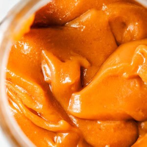 a lot of velvety salted caramel sauce in a glass jar.