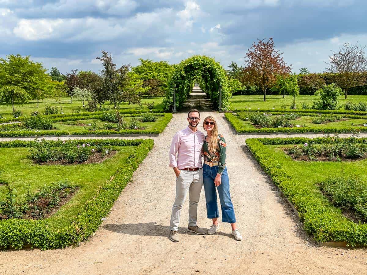 man and woman standing in formal garden.