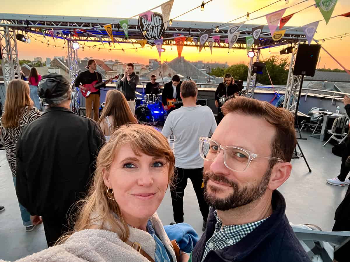 man and woman standing in front of a band.