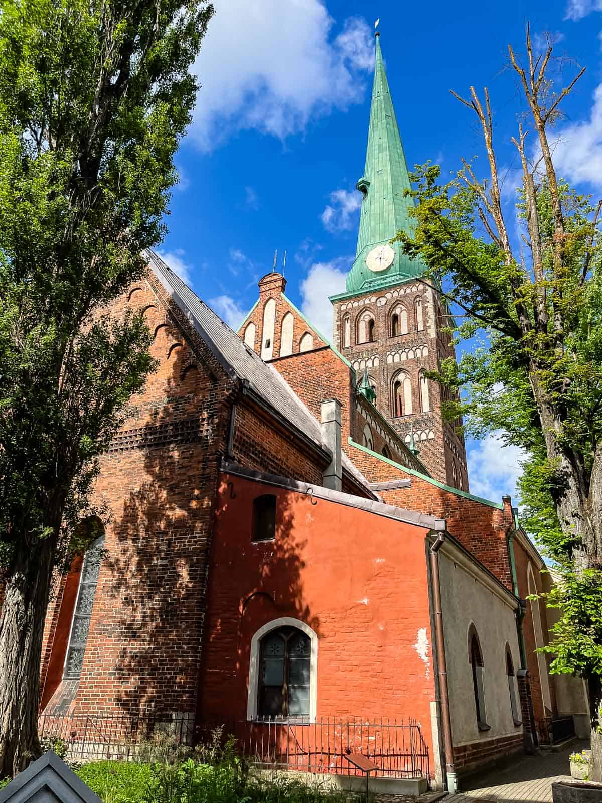 Church with copper steeple and red brick.
