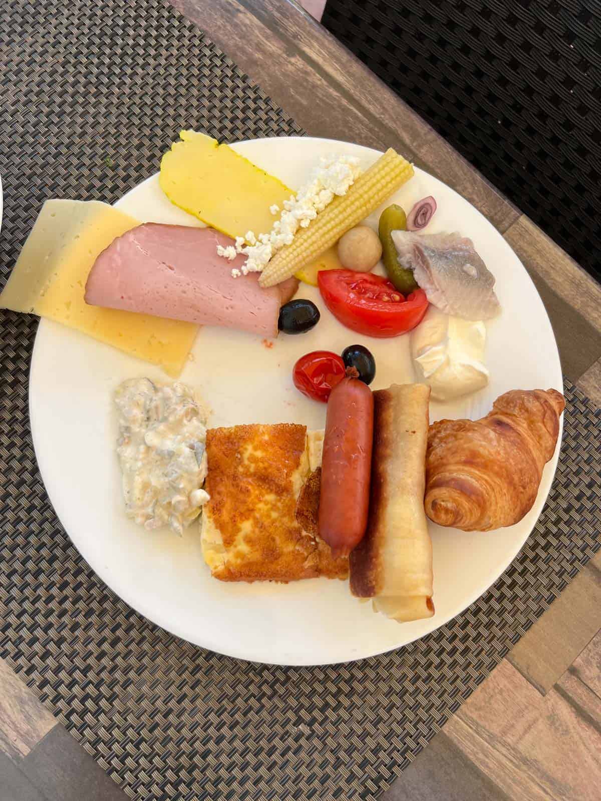 breakfast plate in Latvia, charcuterie and pastries.
