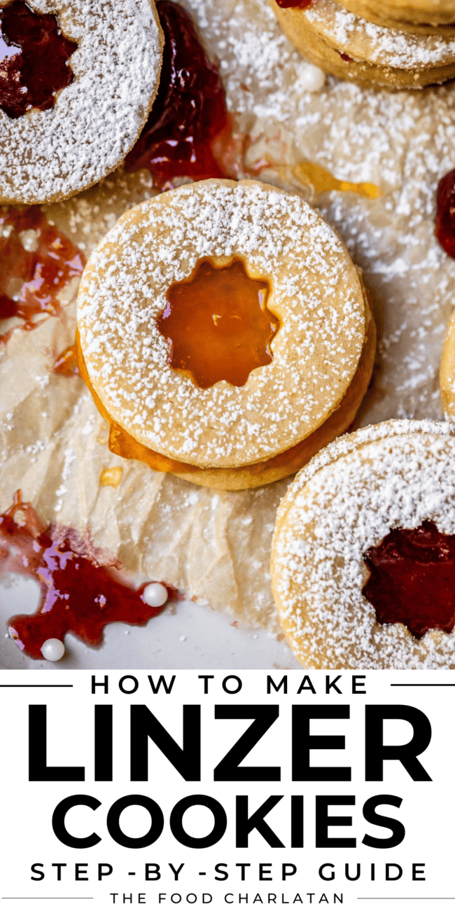 round butter cookie with a cutout of orange apricot jam with powdered sugar.