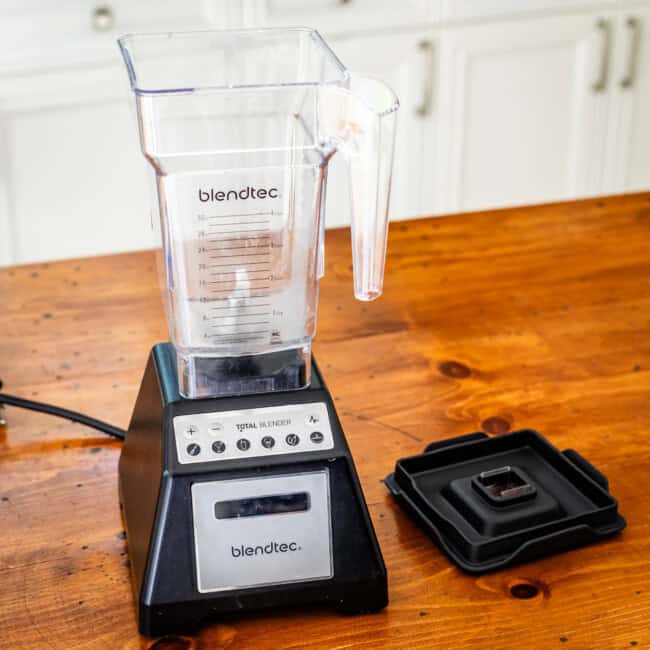 Blendtec blender on wooden table.
