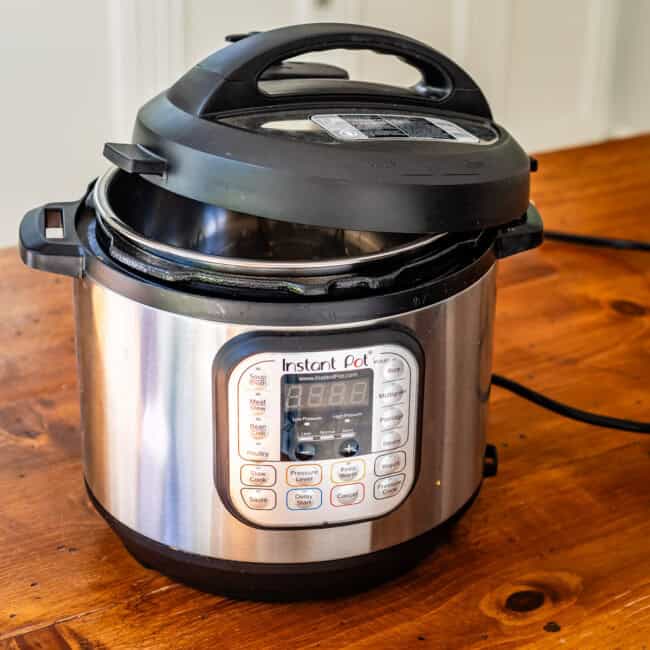 Instant pot on wooden table.