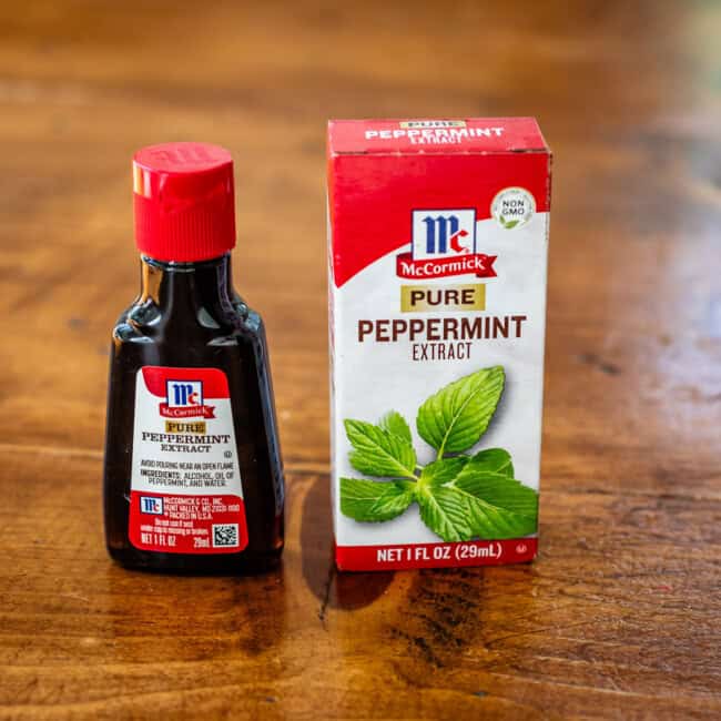 Pure peppermint extract container on wooden table.