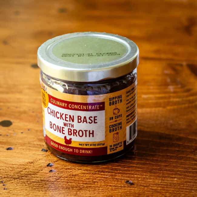 Zoup! Chicken base with bone broth concentrate on wooden table.