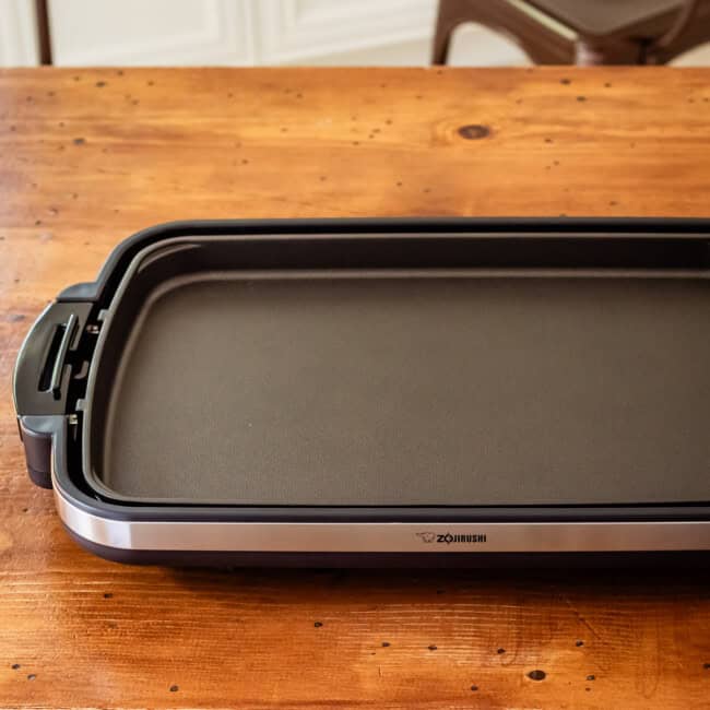 Zojirushi griddle on wood table.