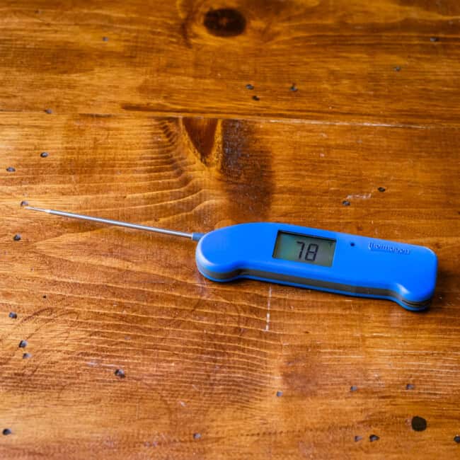 Thermapen on wooden table.