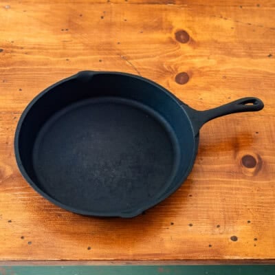 Lodge cast iron skillet on wooden table.
