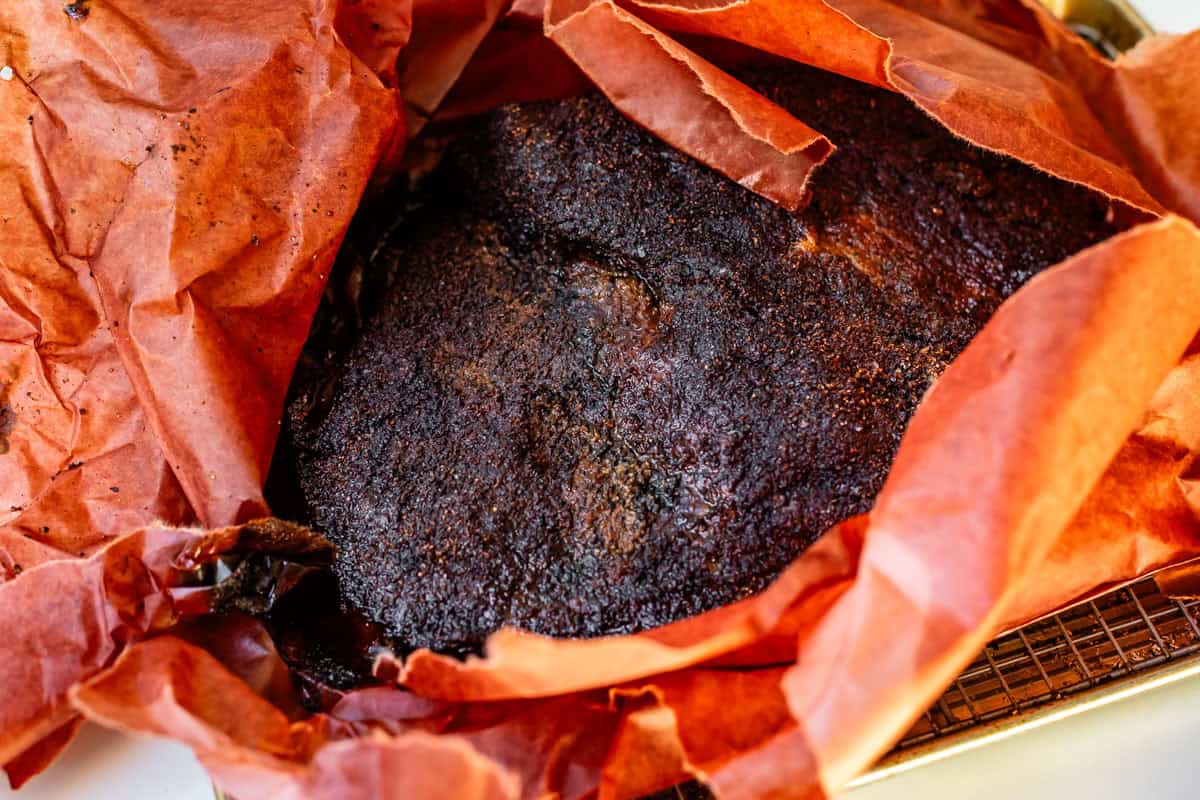 butcher paper all opened up around a finished brisket flat with bark.