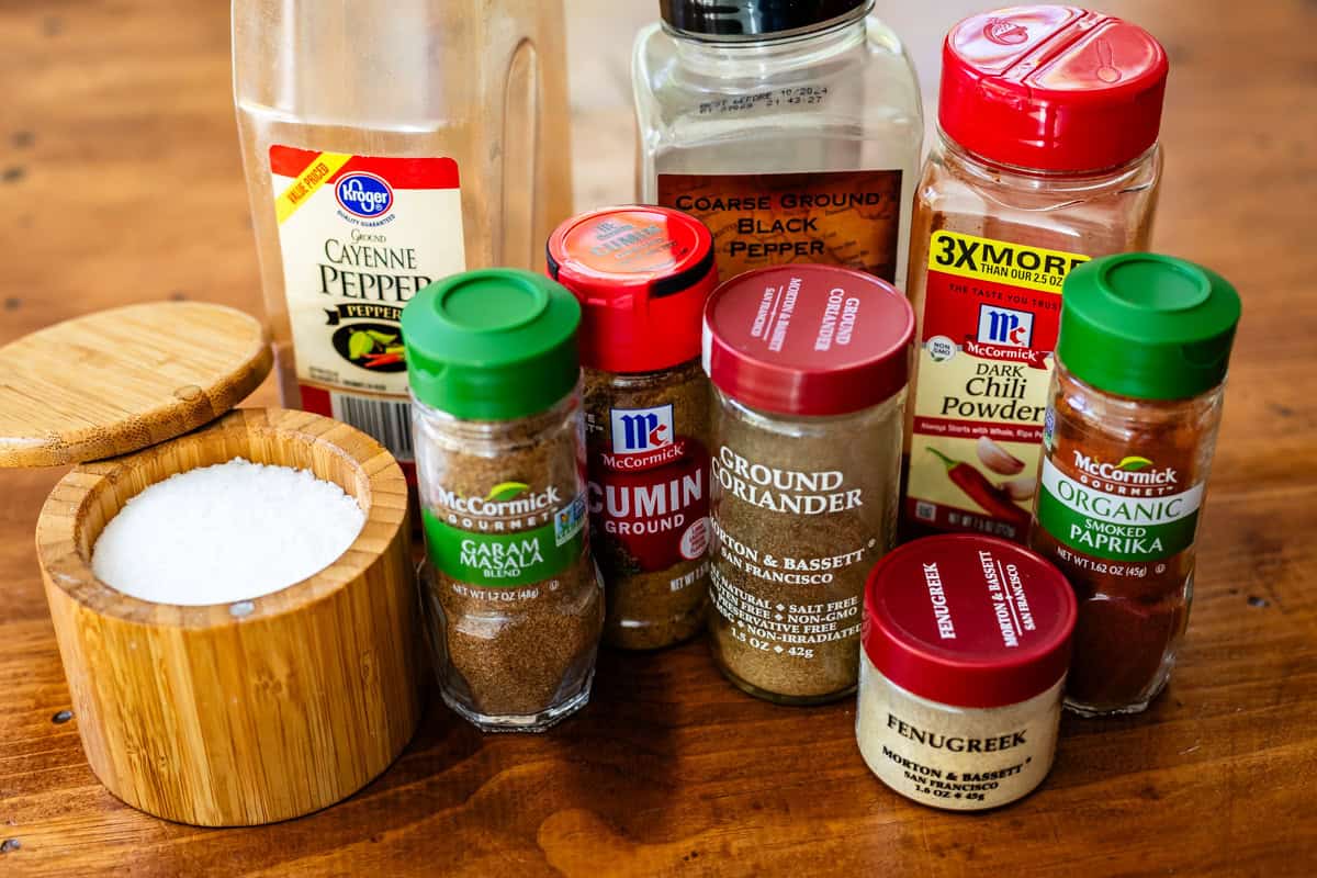 spices for Chicken tikka masala on a table, like garam masala, coriander, cumin, etc. 
