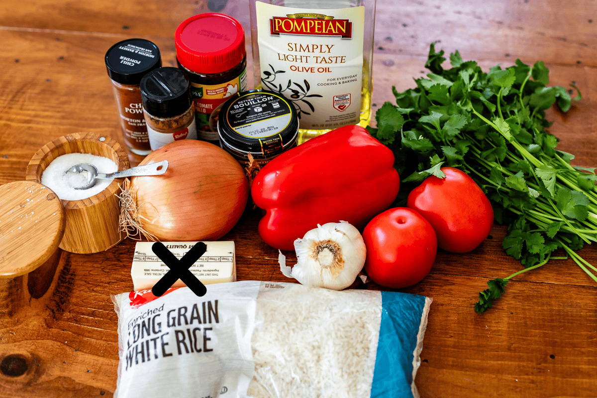 ingredients for mexican rice like onion, tomato, rice, bouillon, and more.