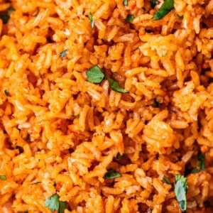 close up showing the detail of Mexican rice cooked in a super flavorful tomato sauce.